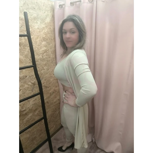 Conjunto feminino de três peças em bege, composto por top cropped, calça ajustada e casaco longo.
