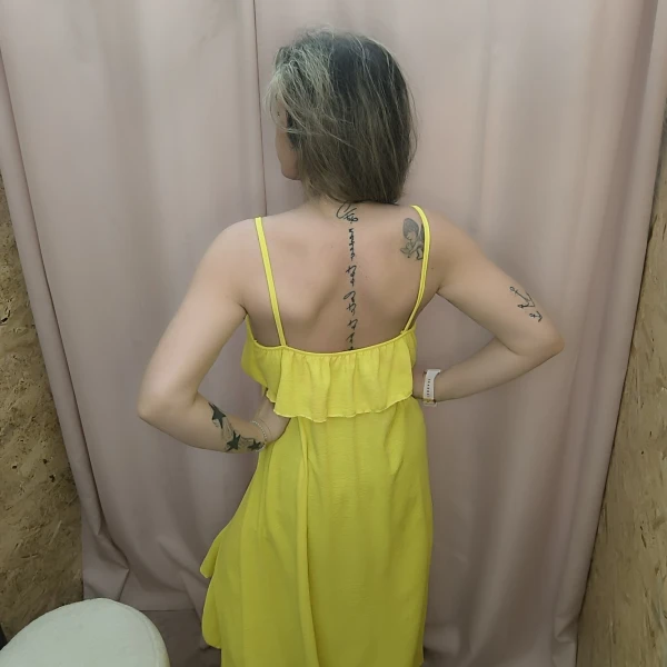 Mulher a usar o top fluide à volants em diferentes cores e posições.